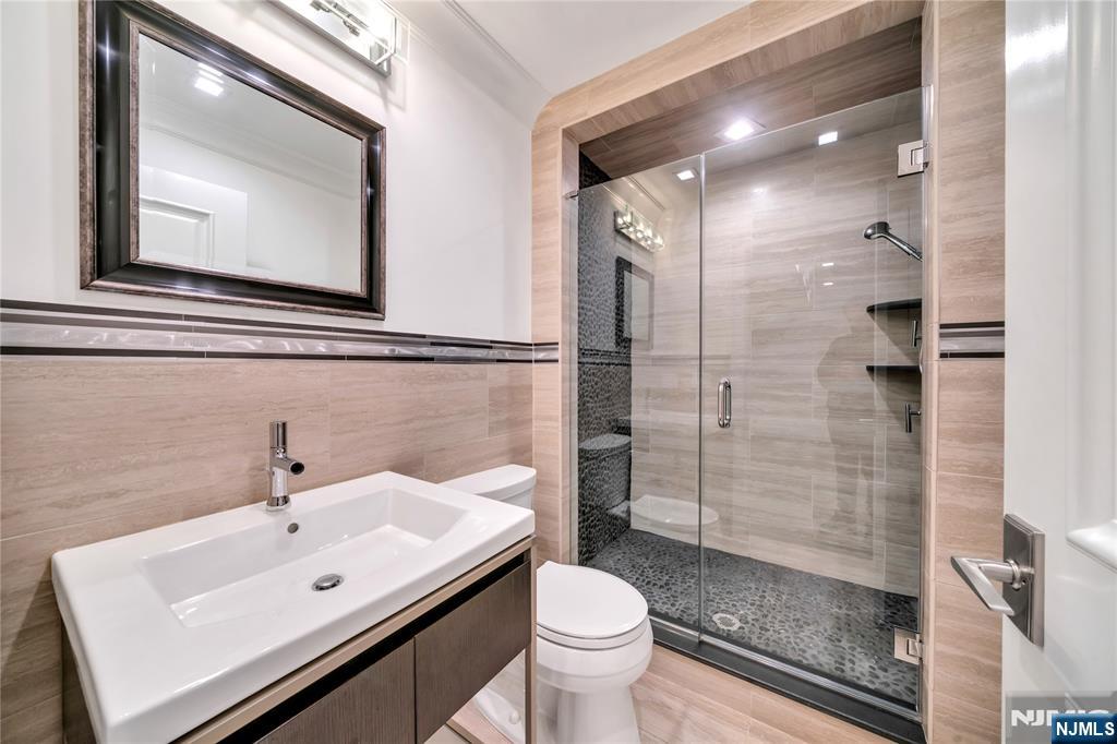 516 Undercliff Avenue Edgewater, NJ 07020 - Photo 32 of 32 a bathroom with a sink toilet and shower