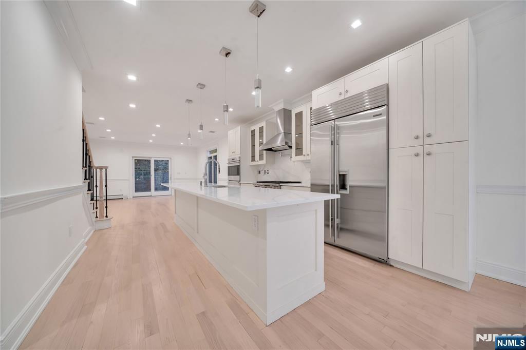 516 Undercliff Avenue Edgewater, NJ 07020 - Photo 4 of 32 a view of kitchen with stainless steel appliances refrigerator stove microwave and cabinets