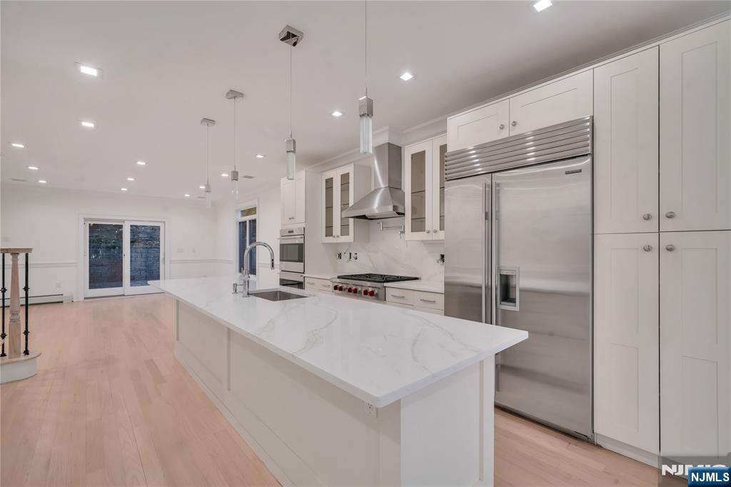 516 Undercliff Avenue Edgewater, NJ 07020 - Photo 5 of 32 a kitchen with stainless steel appliances a refrigerator sink and stove