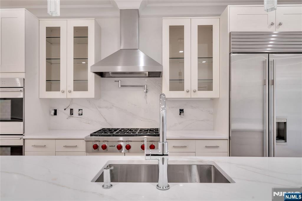 516 Undercliff Avenue Edgewater, NJ 07020 - Photo 6 of 32 a kitchen with a sink a stove and refrigerator