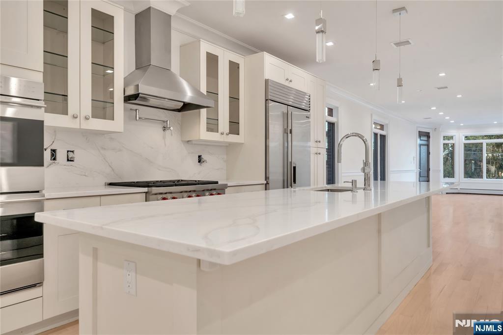 516 Undercliff Avenue Edgewater, NJ 07020 - Photo 8 of 32 a kitchen with stainless steel appliances a sink stove and refrigerator
