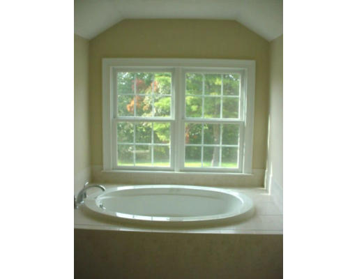 240 Gleasondale Road Stow, MA 01775 - Photo 11 of 13 a bath tub sitting in a bathroom next to a window