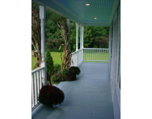 240 Gleasondale Road Stow, MA 01775 - Photo 7 of 13 a view of a porch with furniture and garden
