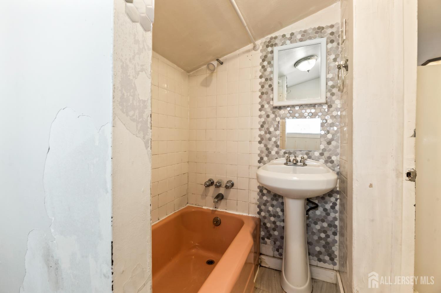 45 Loring Avenue Edison, NJ 08817 - Photo 15 of 23 a bathroom with a sink and mirror with bathtub