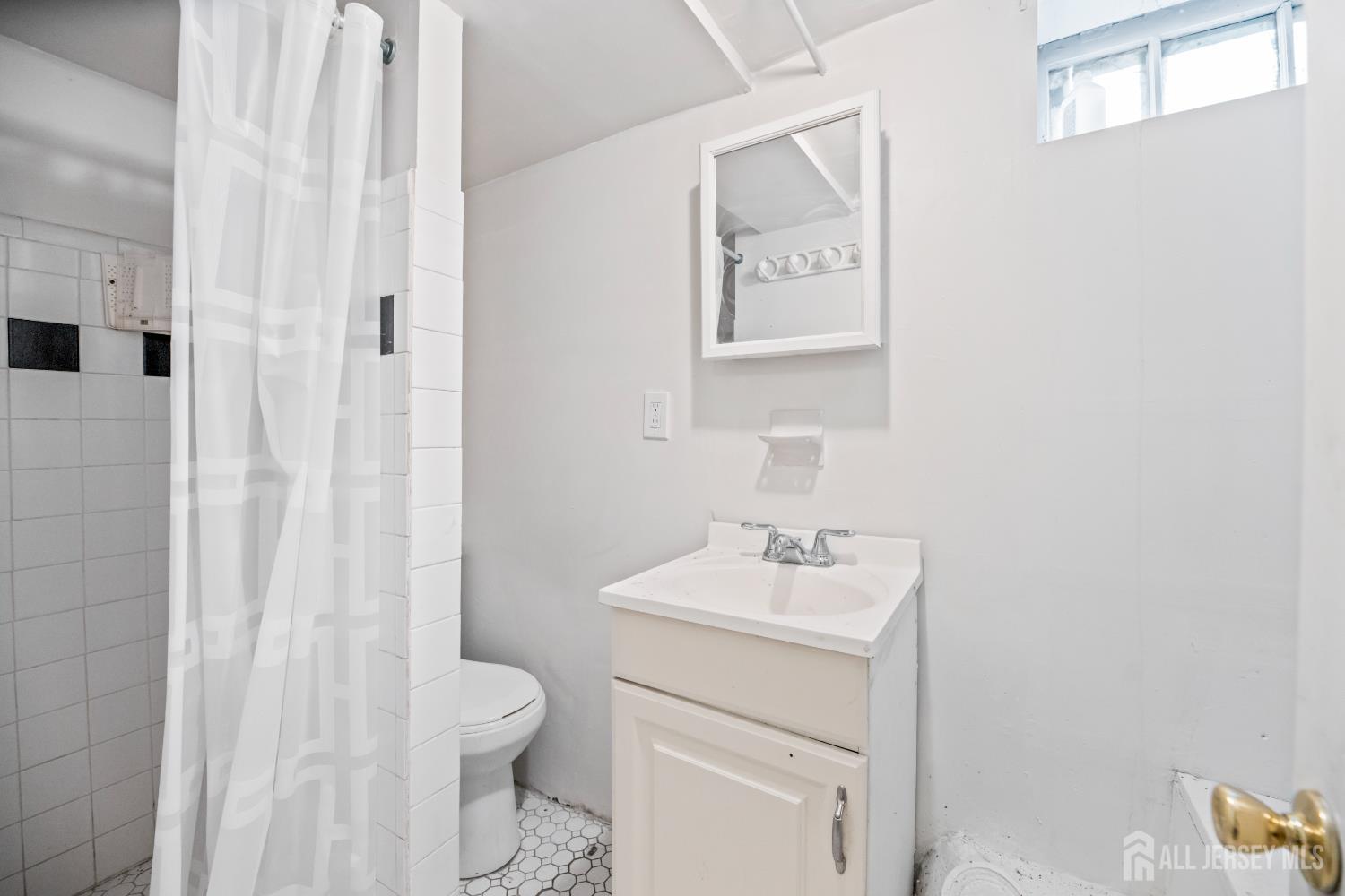 45 Loring Avenue Edison, NJ 08817 - Photo 17 of 23 a bathroom with a sink toilet and vanity