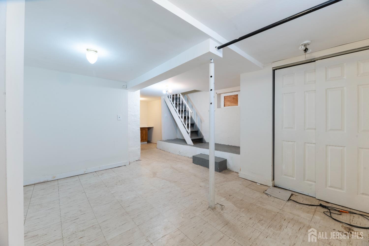 45 Loring Avenue Edison, NJ 08817 - Photo 19 of 23 an empty room with a bench and white walls