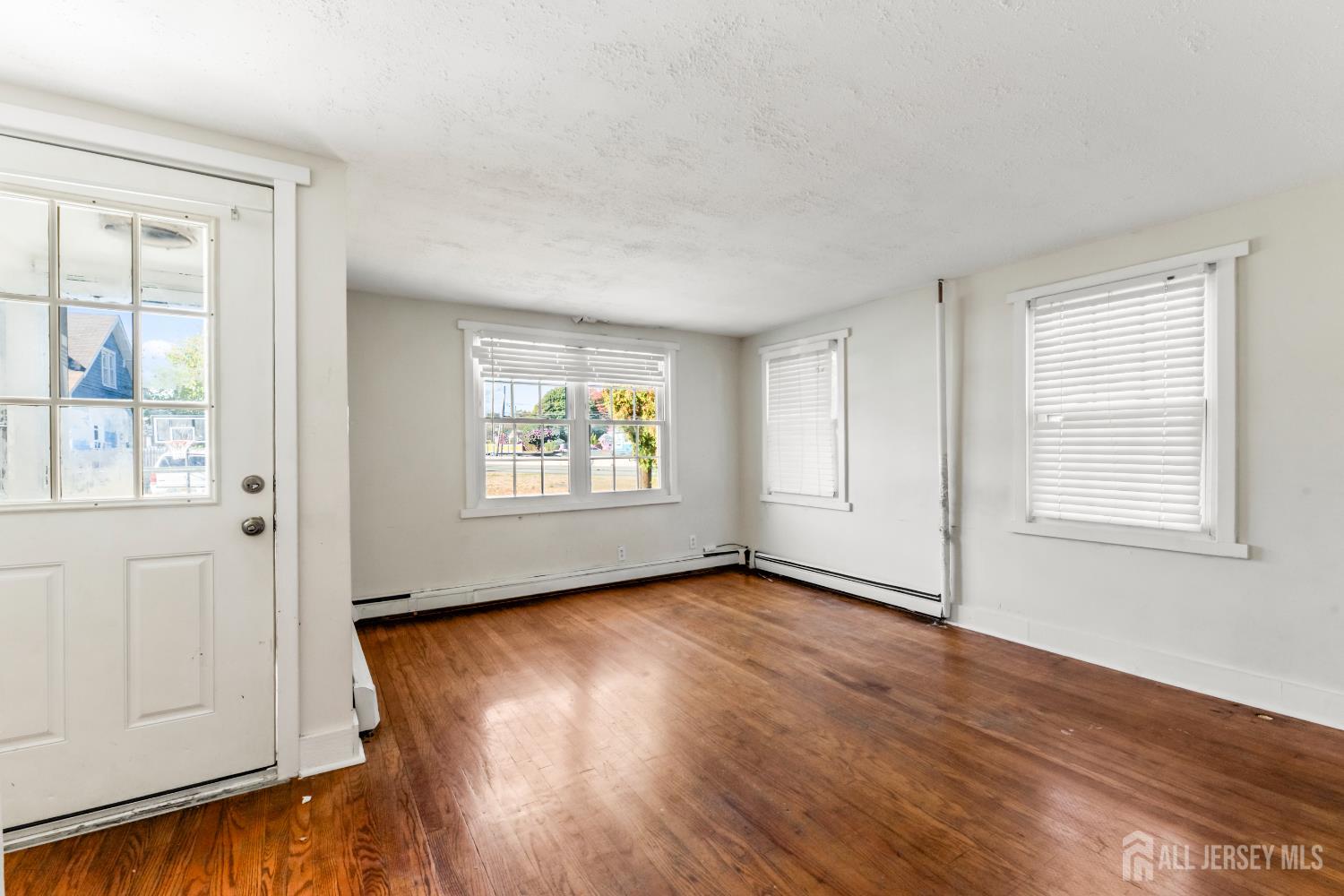 45 Loring Avenue Edison, NJ 08817 - Photo 3 of 23 an empty room with wooden floor and windows
