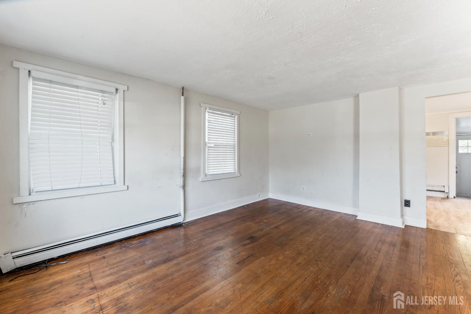 45 Loring Avenue Edison, NJ 08817 - Photo 5 of 23 an empty room with wooden floor and windows