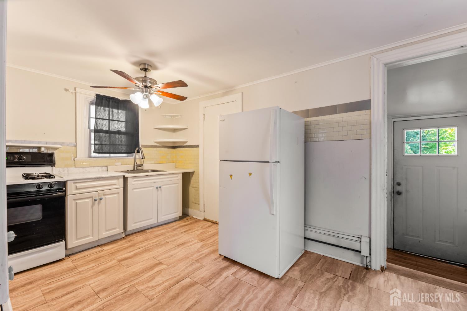 45 Loring Avenue Edison, NJ 08817 - Photo 7 of 23 a kitchen with a refrigerator a stove top oven a sink and dishwasher
