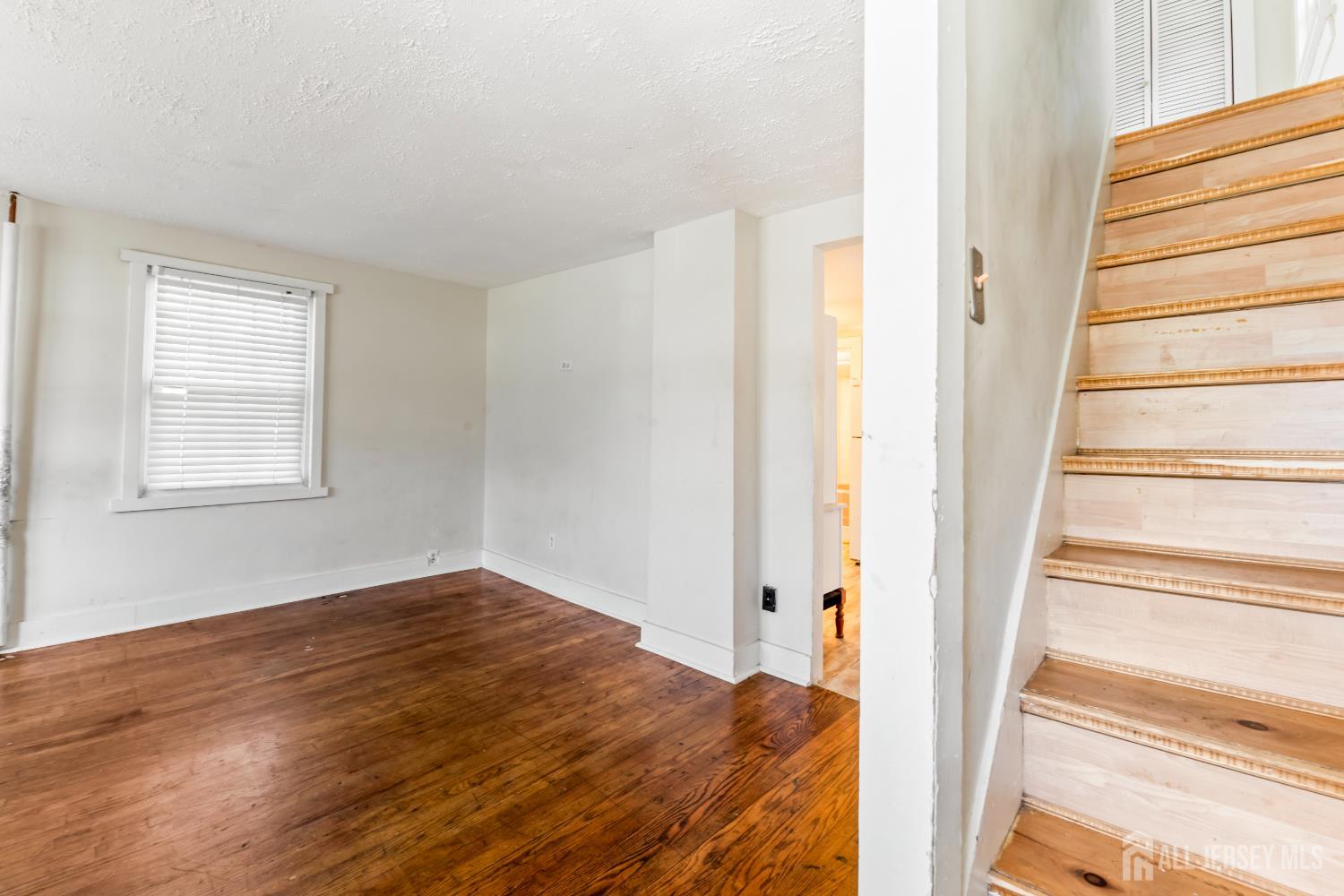 45 Loring Avenue Edison, NJ 08817 - Photo 9 of 23 a view of an empty room with wooden floor and a window