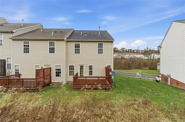 an aerial view of a house with outdoor seating