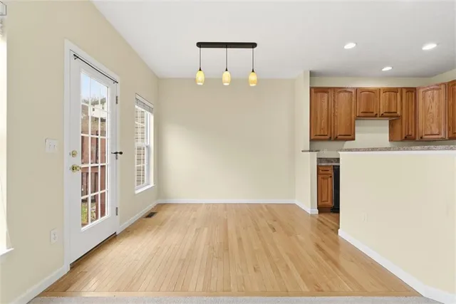 a view of kitchen with furniture and wooden floor