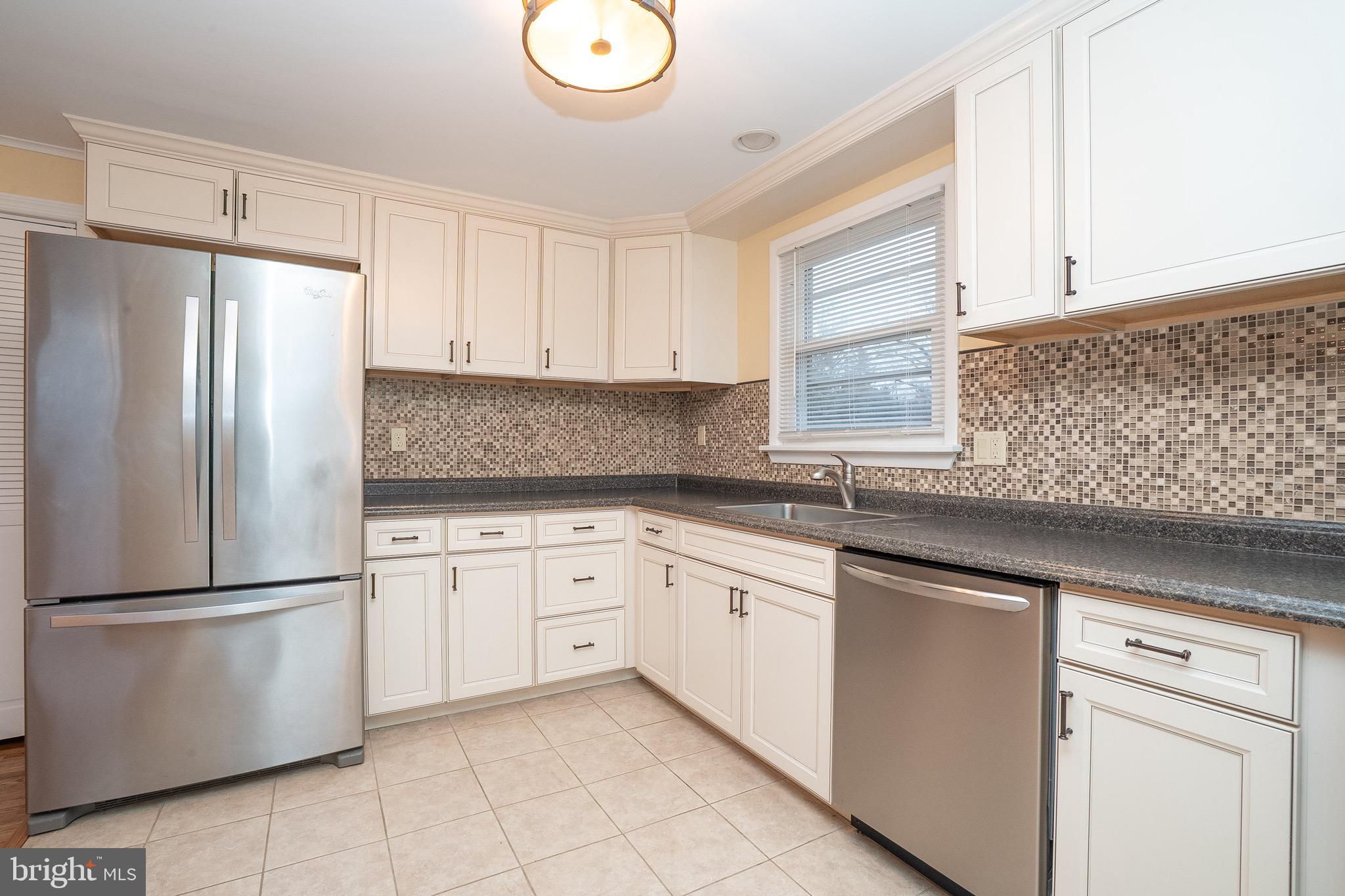 15 Cranbury Road, Unit 1 Princeton Junction, NJ 08550 - Photo 6 of 18 a kitchen with granite countertop white cabinets stainless steel appliances and a sink