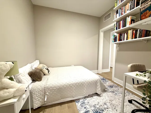 a bedroom with a bed and a book shelf