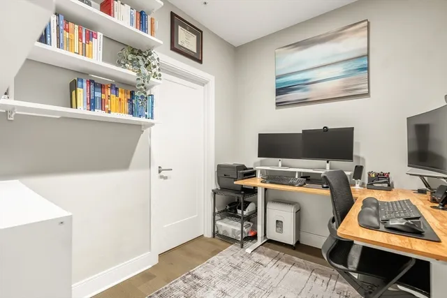 a view of a livingroom with workspace and a window