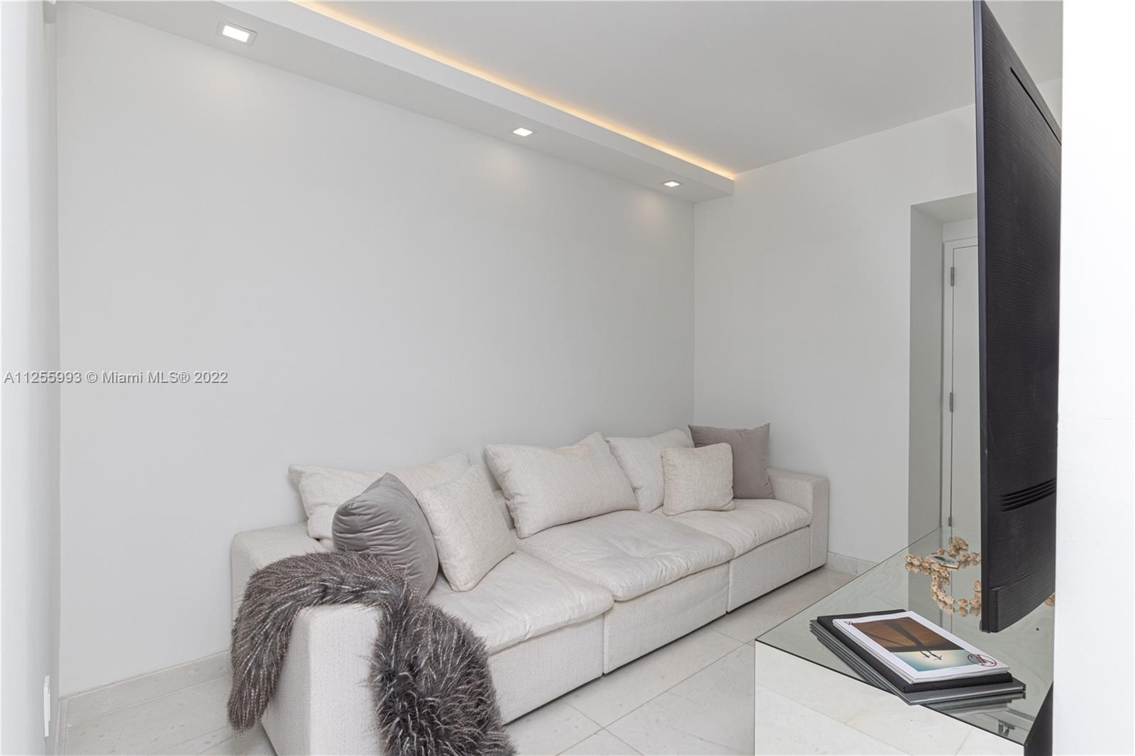 1010 Brickell Avenue, Unit 3003 Miami, FL 33131 - Photo 11 of 32 a living room with furniture and a window