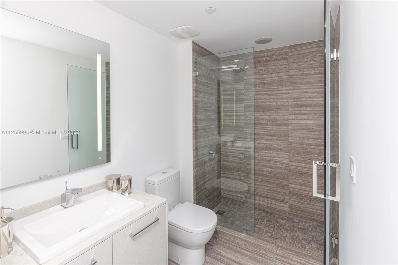 1010 Brickell Avenue, Unit 3003 Miami, FL 33131 - Photo 13 of 32 a bathroom with a sink toilet and shower