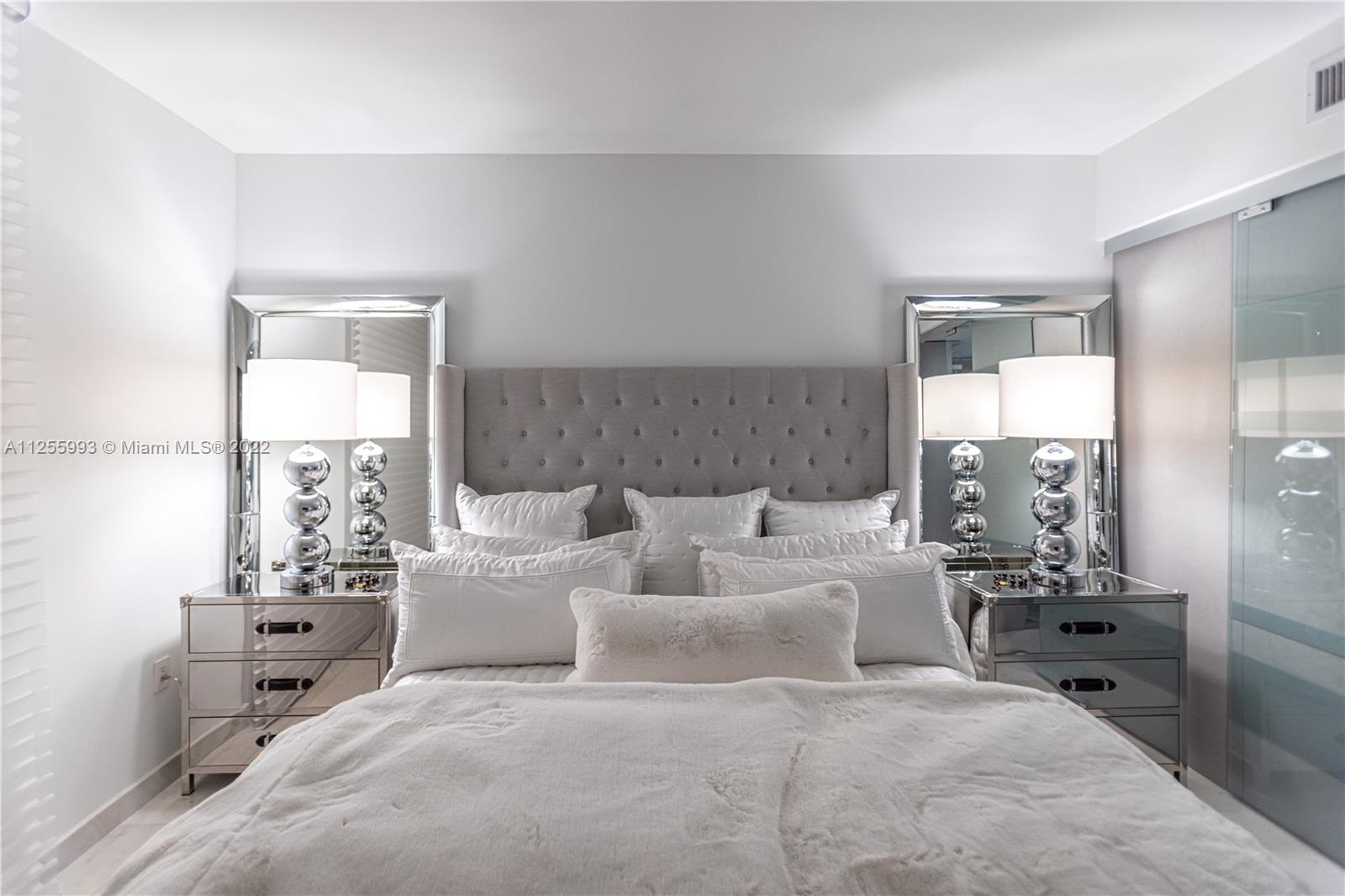 1010 Brickell Avenue, Unit 3003 Miami, FL 33131 - Photo 16 of 32 a bed room with a bed and a chair