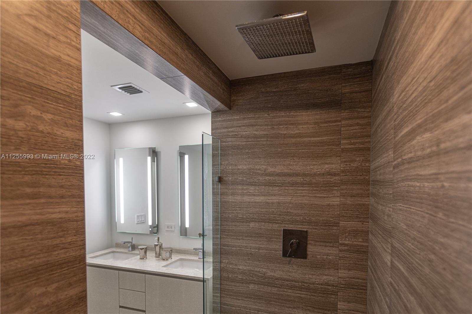 1010 Brickell Avenue, Unit 3003 Miami, FL 33131 - Photo 19 of 32 a bathroom with a sink and a mirror