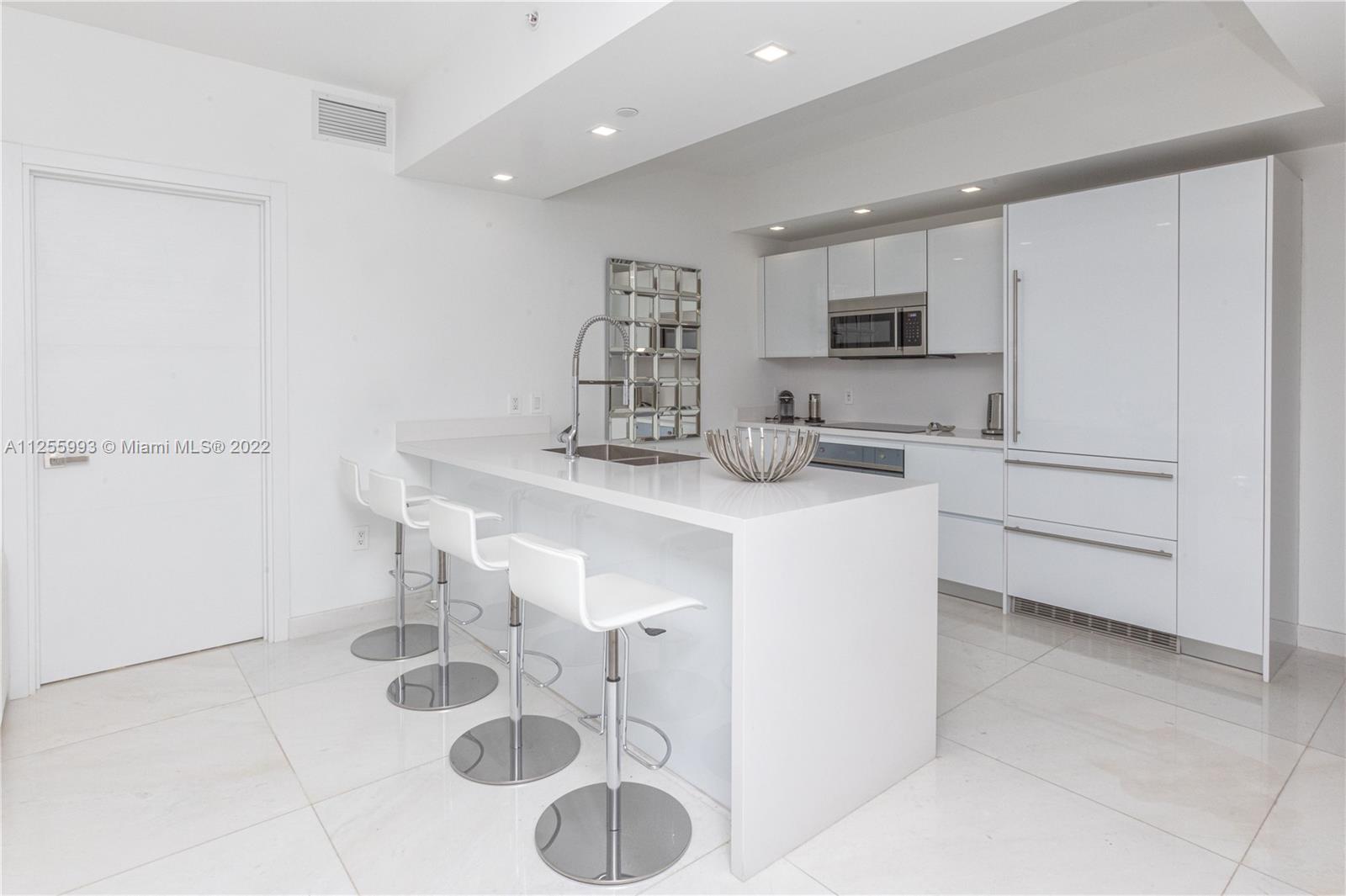 1010 Brickell Avenue, Unit 3003 Miami, FL 33131 - Photo 5 of 32 a kitchen with a sink cabinets and appliances