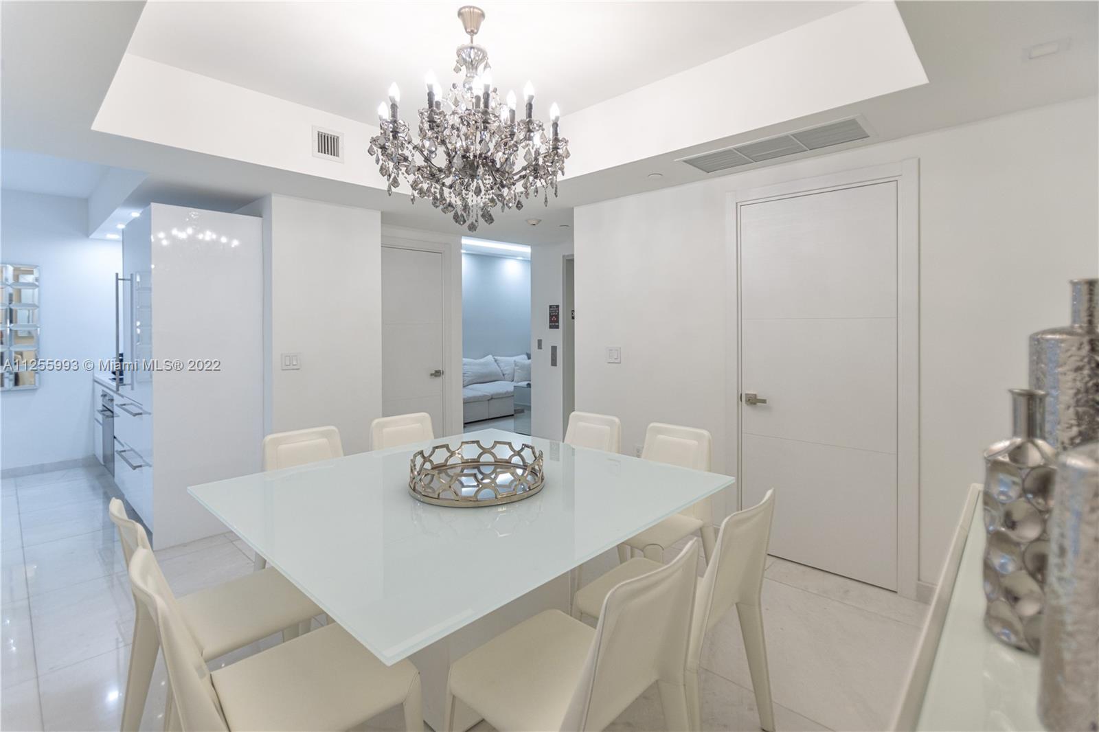1010 Brickell Avenue, Unit 3003 Miami, FL 33131 - Photo 8 of 32 a view of a dining room with furniture and chandelier