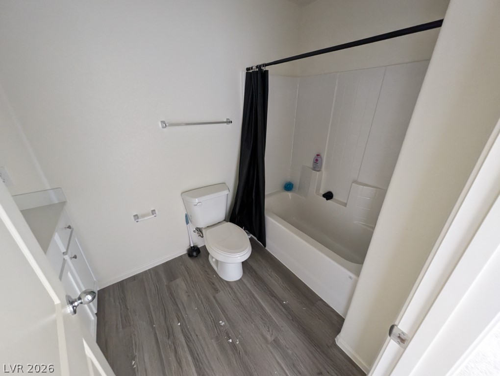 4820 Orchid Rdg Avenue Las Vegas, NV 89141 - Photo 13 of 16 A well-lit bathroom showcases durable gray plank flooring and a full tub-shower combination.