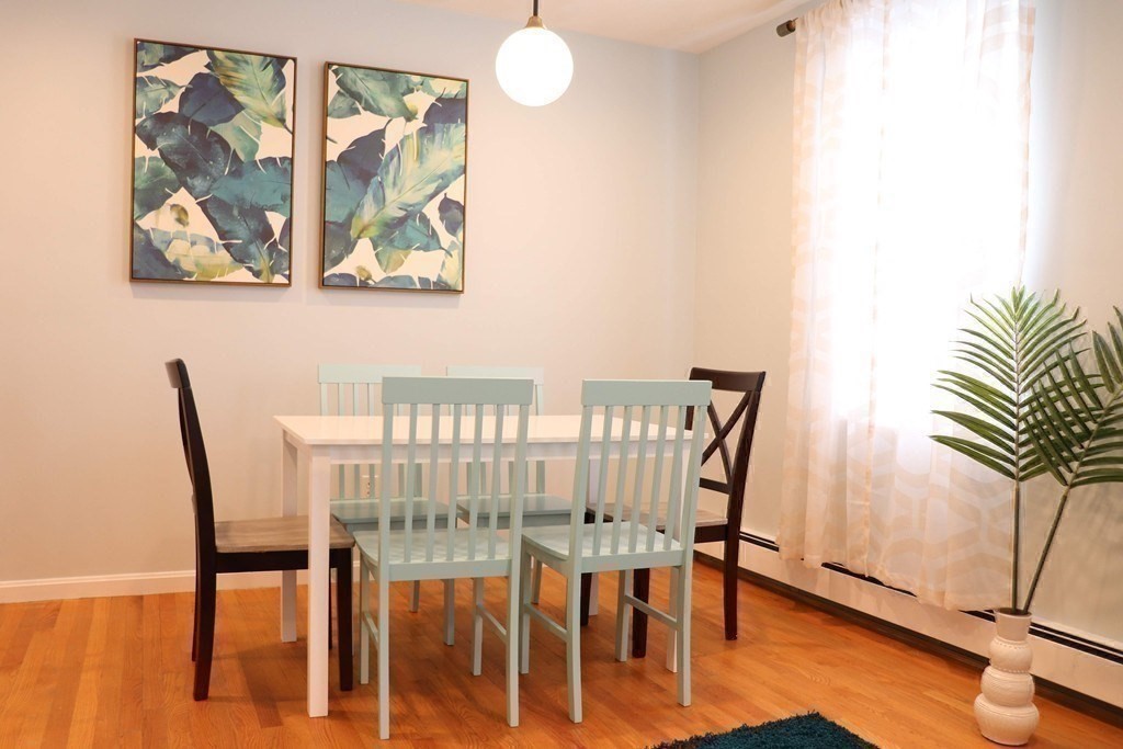 12 Regent Street, Unit 2 Cambridge, MA 02140 - Photo 13 of 42 a view of a dining room with furniture and wooden floor