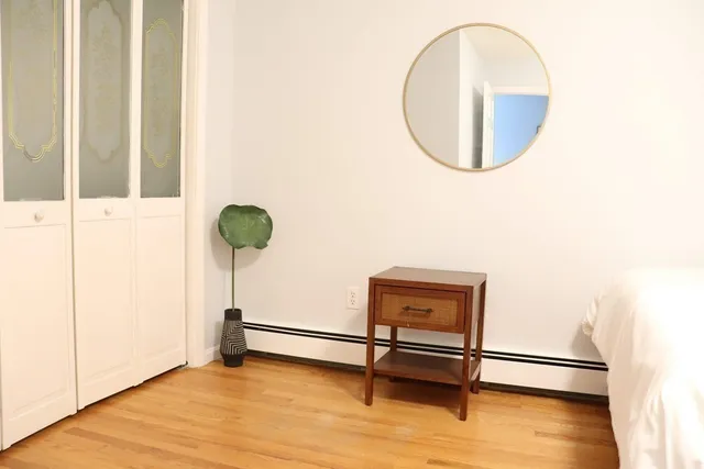 a large bed sitting in a bedroom next to a window