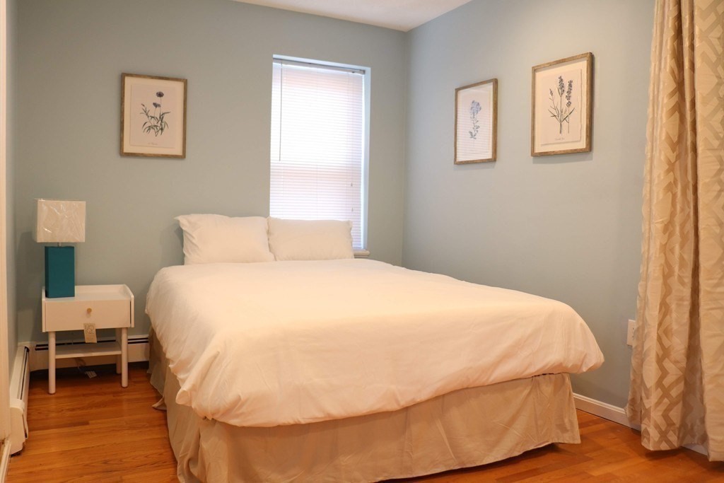 12 Regent Street, Unit 2 Cambridge, MA 02140 - Photo 17 of 42 a large bed sitting in a bedroom next to a window