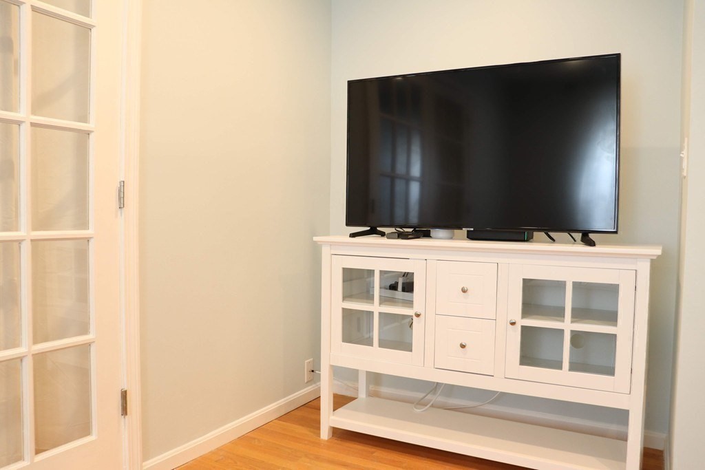 12 Regent Street, Unit 2 Cambridge, MA 02140 - Photo 19 of 42 a view of an empty room with wooden floor and cabinet