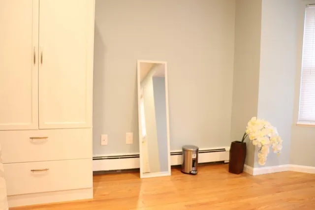 a large bed sitting in a bedroom with a large window