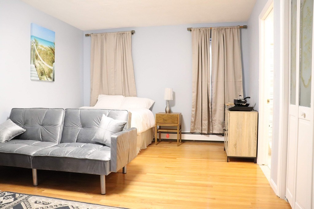 12 Regent Street, Unit 2 Cambridge, MA 02140 - Photo 25 of 42 a living room with furniture and a window