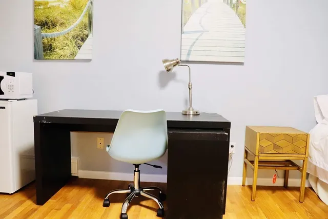 a living room with furniture and a lamp