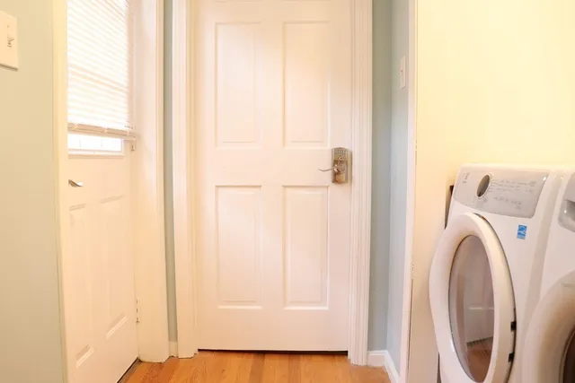 a large bed sitting in a bedroom next to a window
