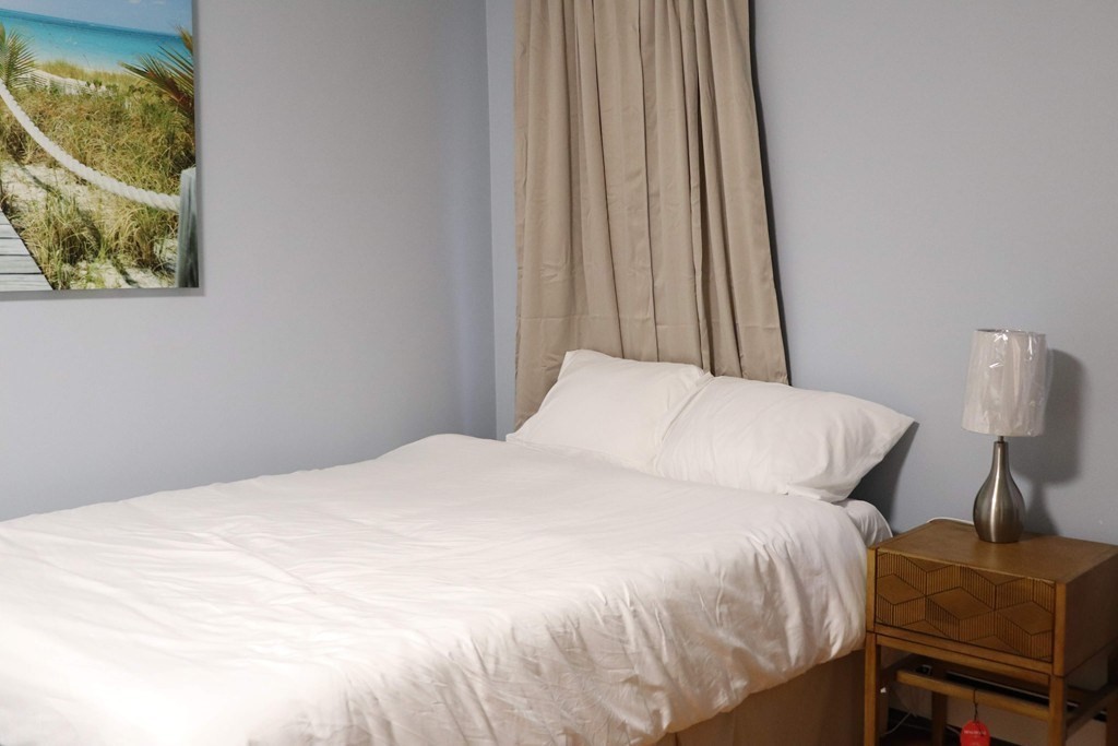 12 Regent Street, Unit 2 Cambridge, MA 02140 - Photo 35 of 42 a large bed sitting in a bedroom next to a window