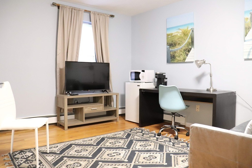 12 Regent Street, Unit 2 Cambridge, MA 02140 - Photo 36 of 42 a living room with furniture and a flat screen tv