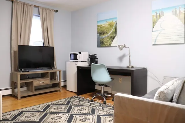 a living room with furniture and a window