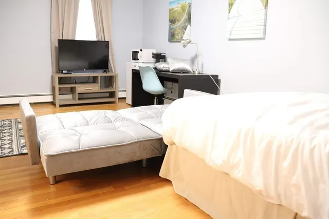 a living room with furniture and a lamp