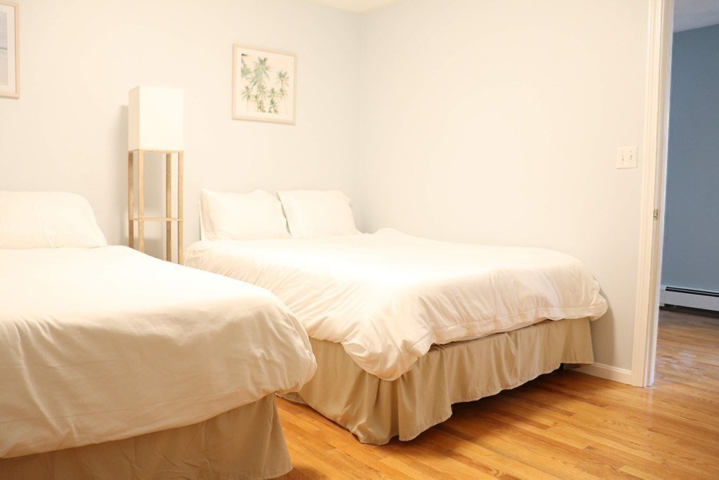 12 Regent Street, Unit 2 Cambridge, MA 02140 - Photo 8 of 42 a bedroom with a bed and a painting on the wall