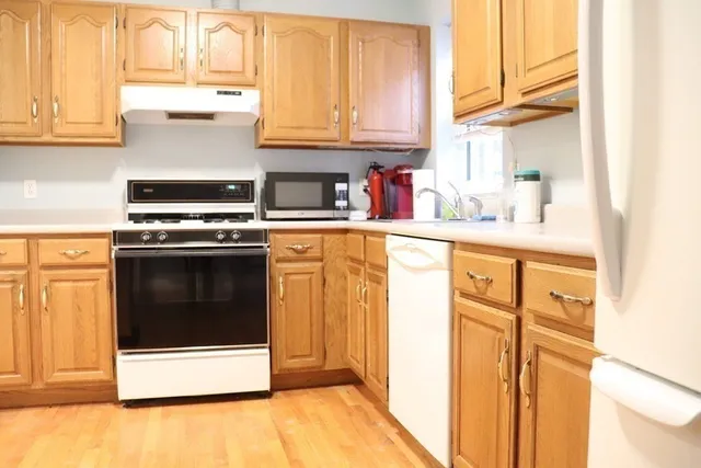 a kitchen with stainless steel appliances granite countertop a stove a microwave and a sink