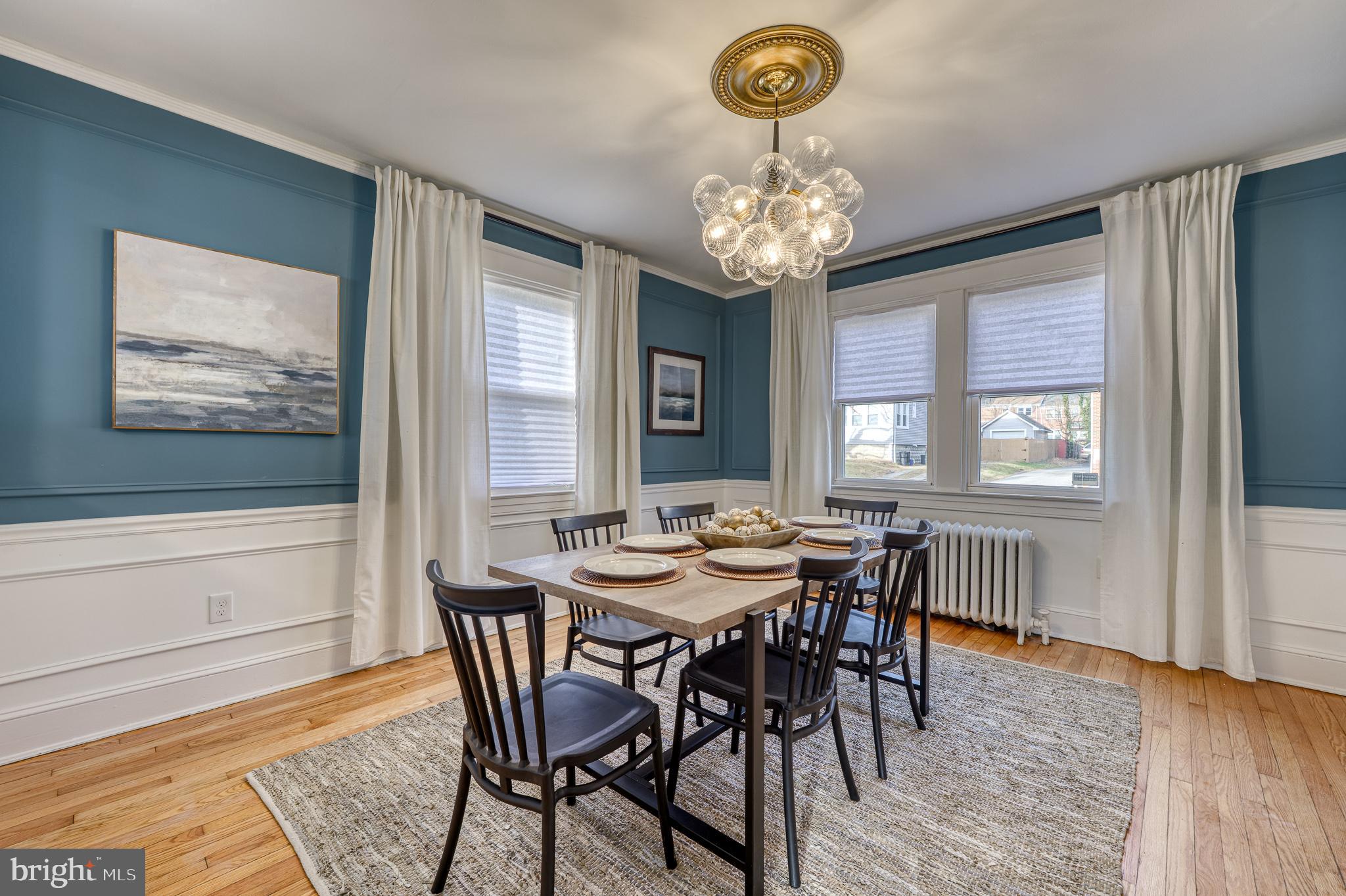 606 Aldershot Road Baltimore, MD 21229 - Photo 13 of 52 a view of a dining room with furniture window and wooden floor