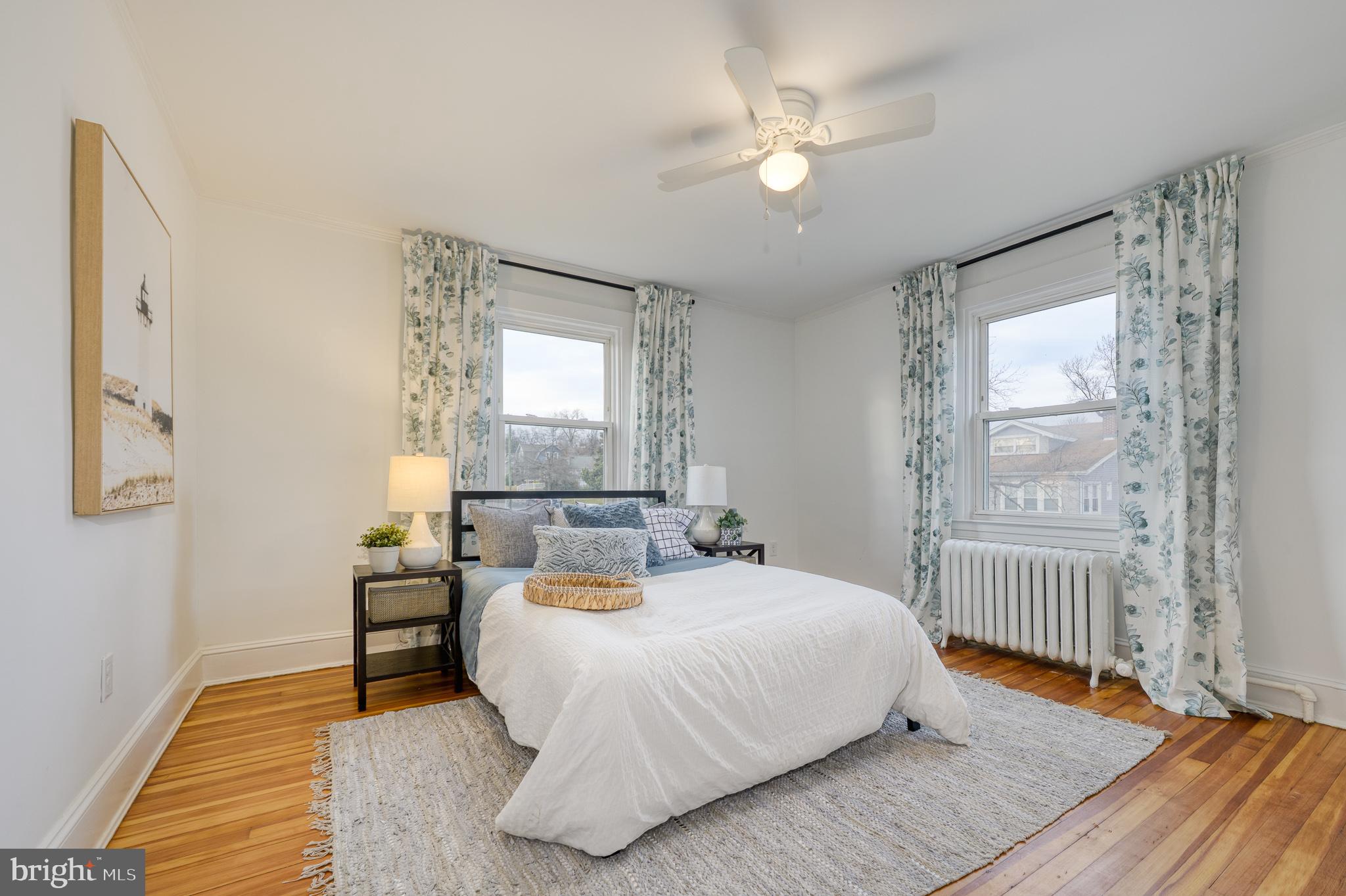 606 Aldershot Road Baltimore, MD 21229 - Photo 40 of 52 a bedroom with a bed and a chandelier