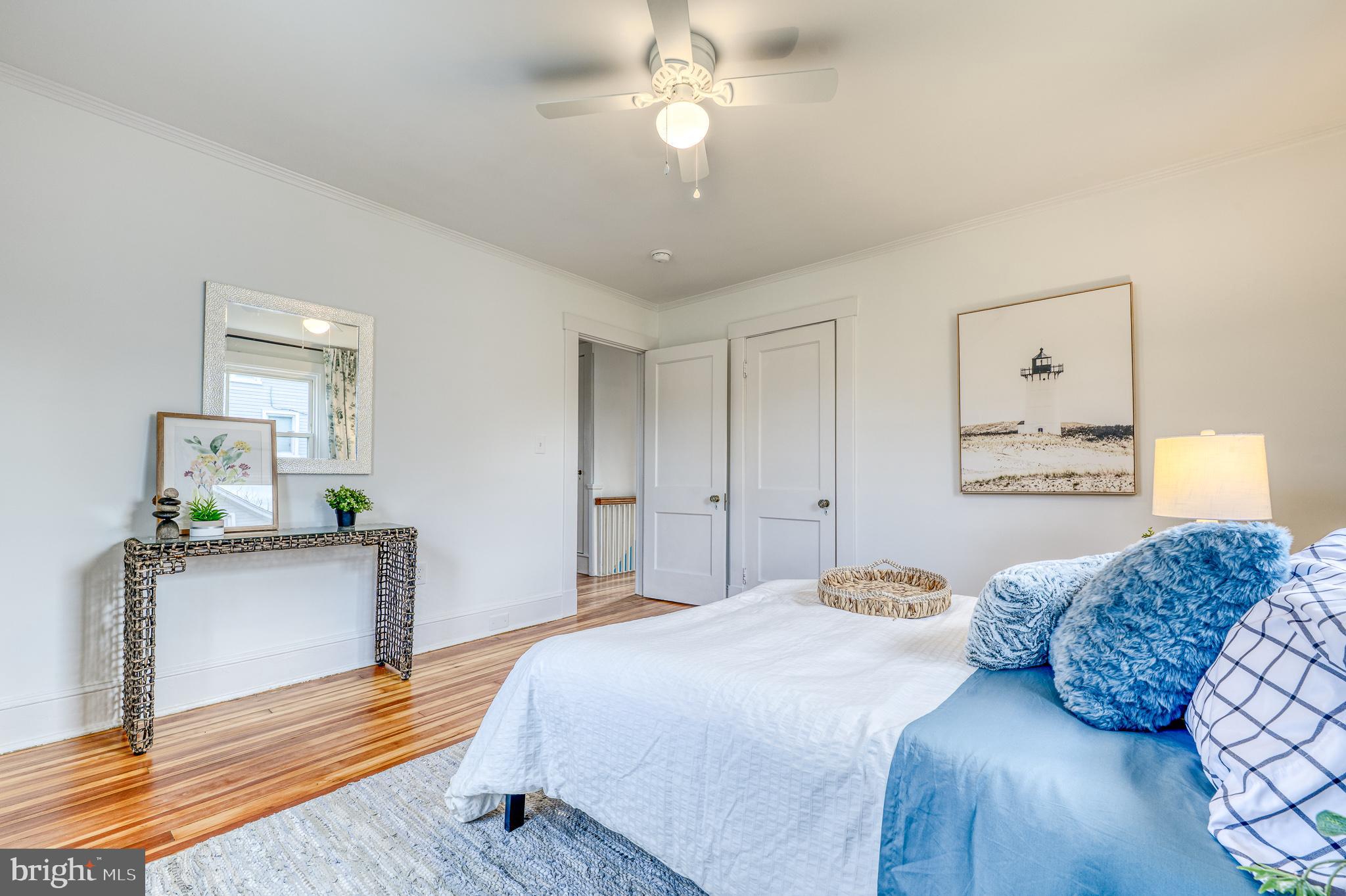 606 Aldershot Road Baltimore, MD 21229 - Photo 42 of 52 a bedroom with a bed and wooden floor