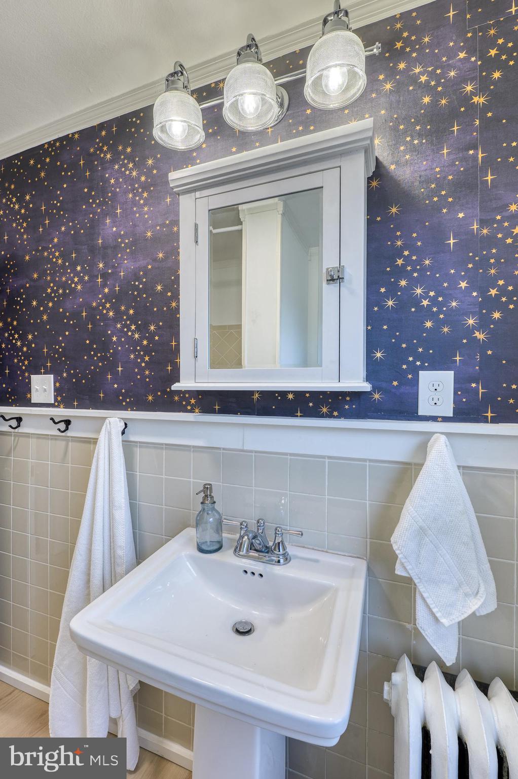 606 Aldershot Road Baltimore, MD 21229 - Photo 9 of 52 a bathroom with a sink and a mirror