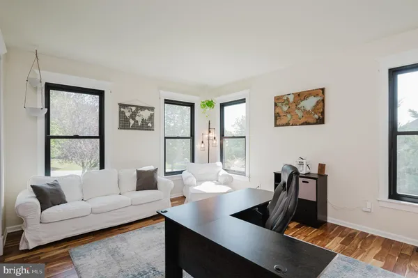 a living room with furniture rug and window