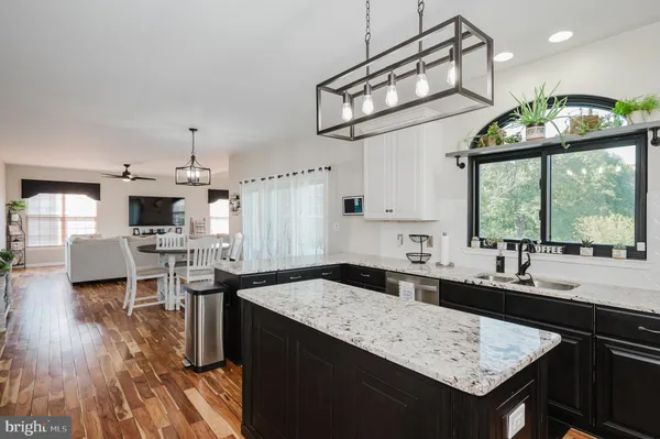 a living room with furniture fireplace and a large window