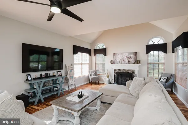 a bedroom with a bed and a flat tv screen on the dresser