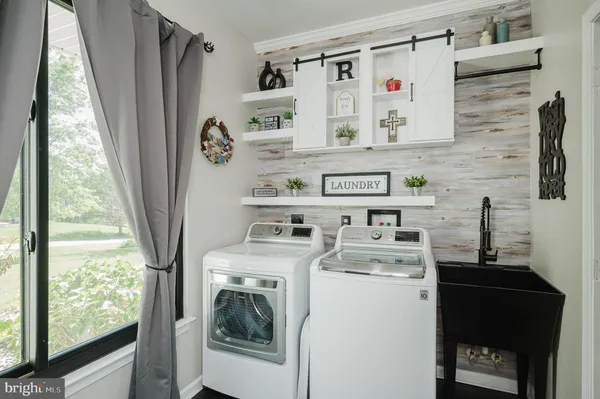 a bedroom with furniture a flat screen tv and a ceiling fan