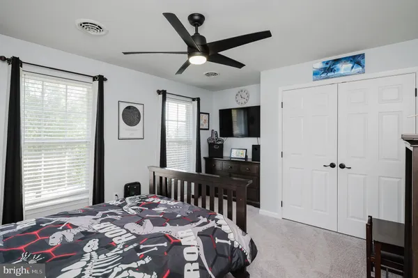 a front view of a house with a garden and yard