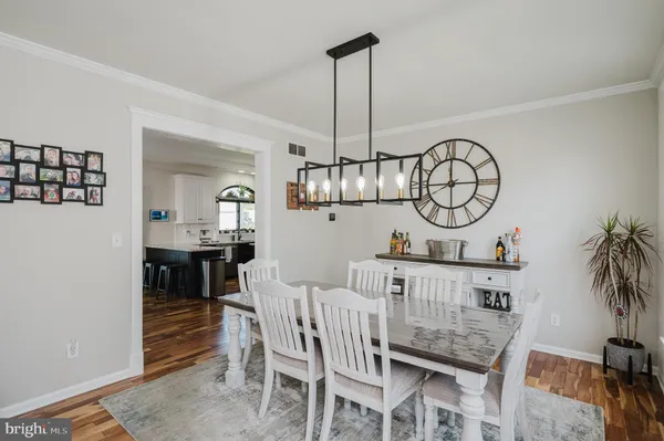 a view of dining room and kitchen with furniture window and wooden floor